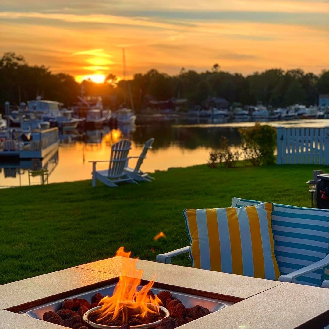 sunset over the kennebunk river by fire at yachtsman hotel marina club bar kennebunkport maine