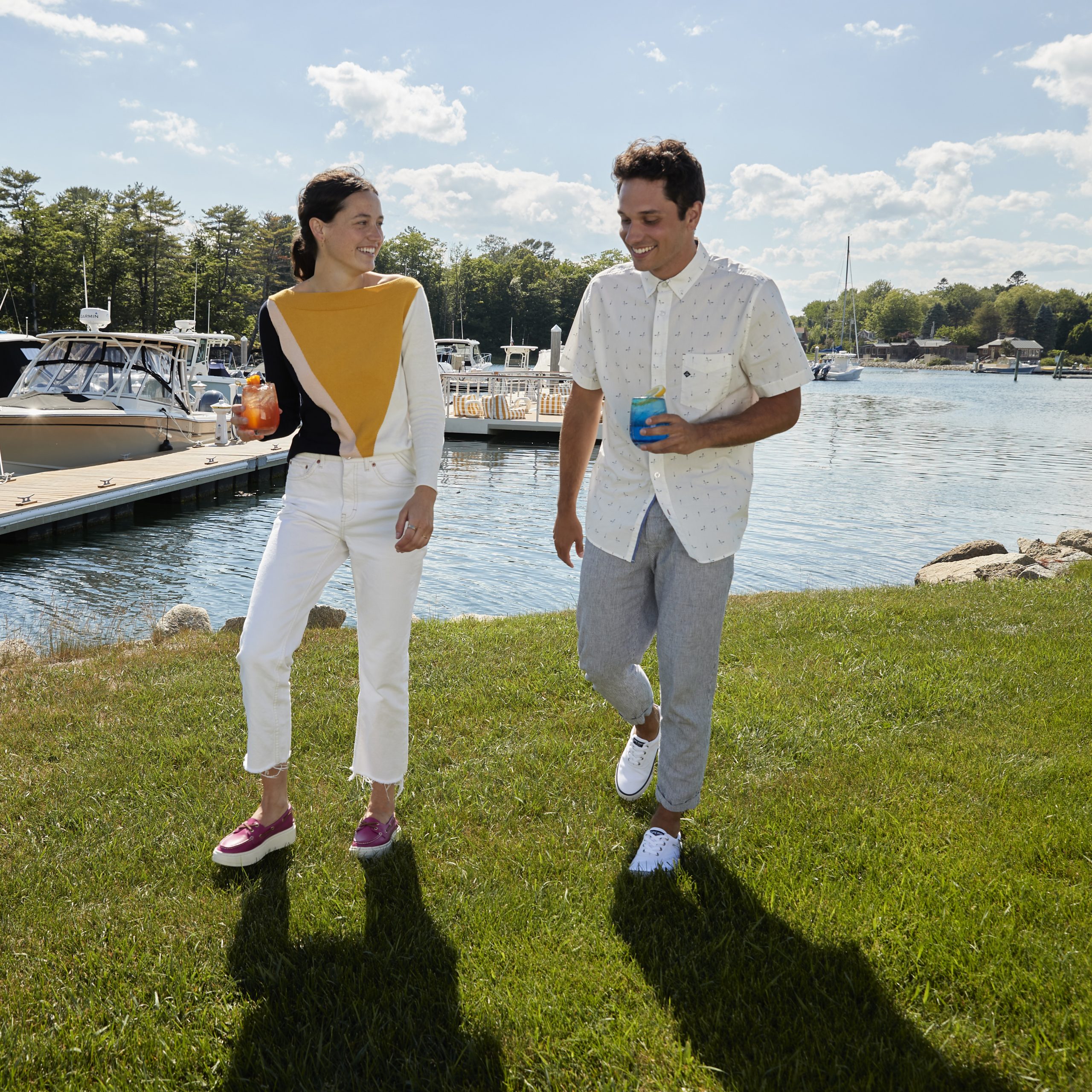 young couple walks along kennebunk river at yachtsman hotel marina club kennebunkport maine resort